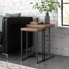 Nesting tables set with wood tops and metal frames, next to a sofa 